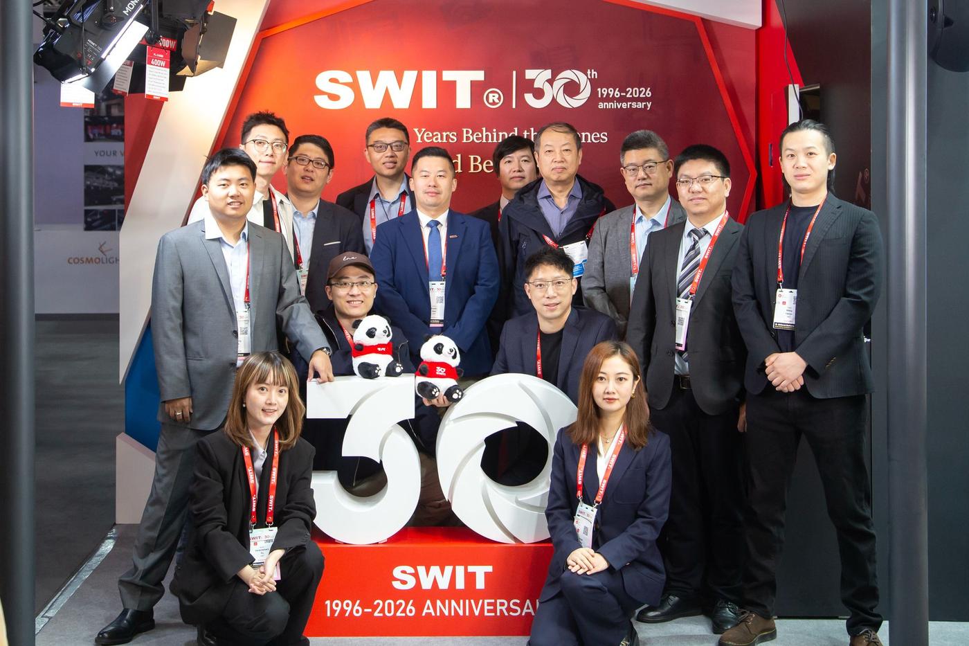 The SWIT team photographed in front of the SWIT 30th anniversary wall at IBC2026